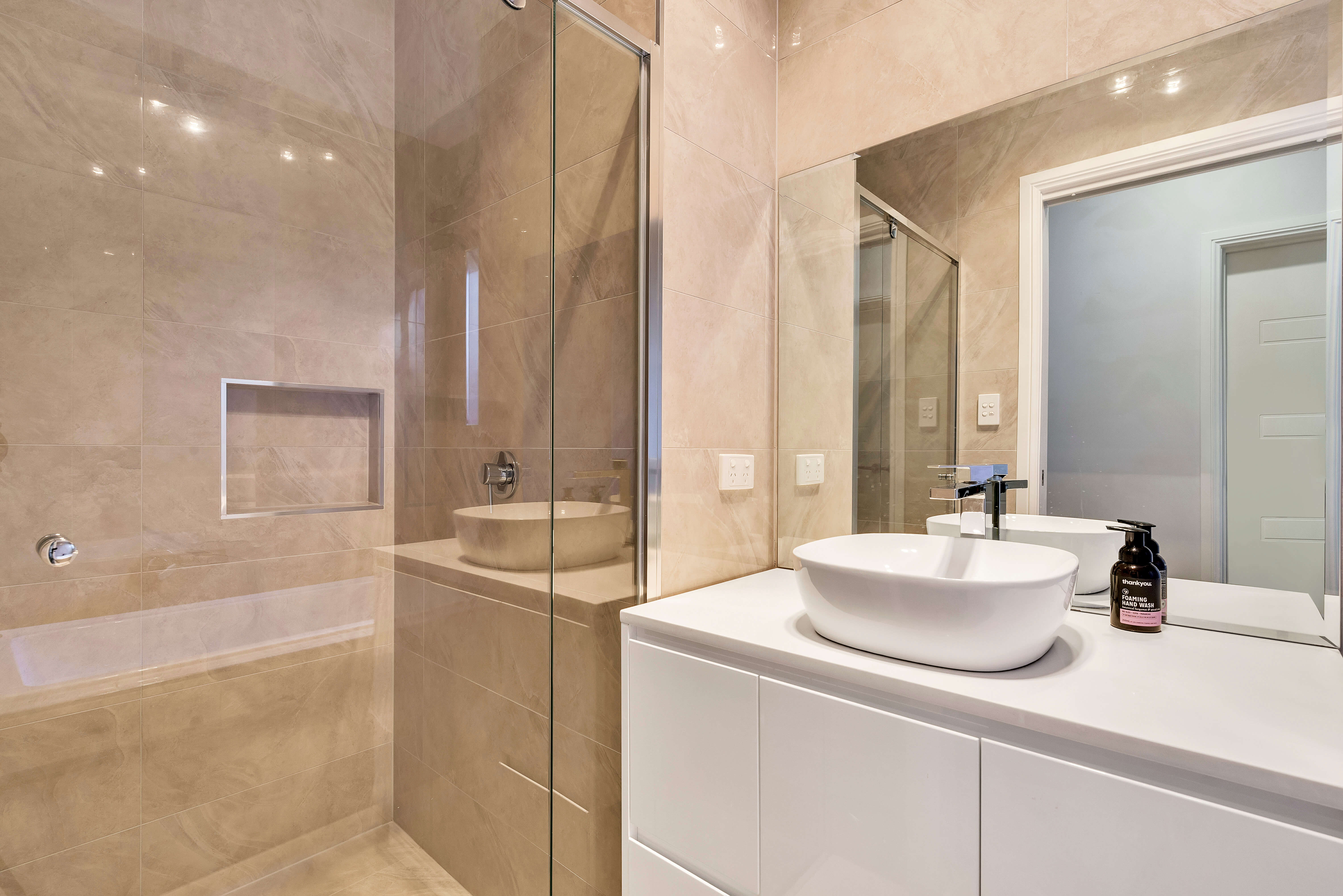 Ensuite vanity with custom storage and quality fixtures in Northfield